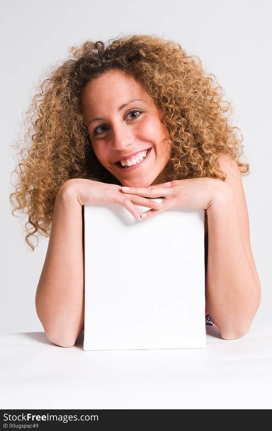 A beautiful and attractive girl holding a billboard. Ready to add your own text. Copy-space on a sign or poster. Young girl holding a sign, advertisement or poster. The concept of this picture is: copy-space on a white board or advertising. A beautiful and attractive girl holding a billboard. Ready to add your own text. Copy-space on a sign or poster. Young girl holding a sign, advertisement or poster. The concept of this picture is: copy-space on a white board or advertising.