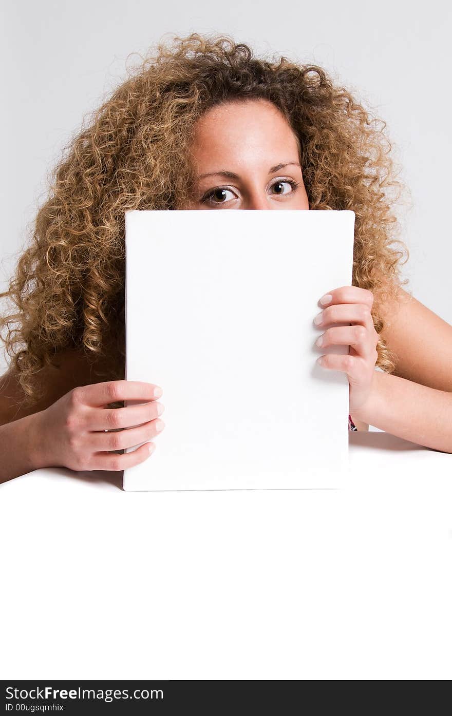 A beautiful and attractive girl holding a billboard. Ready to add your own text. Copy-space on a sign or poster. Young girl holding a sign, advertisement or poster. The concept of this picture is: copy-space on a white board or advertising. A beautiful and attractive girl holding a billboard. Ready to add your own text. Copy-space on a sign or poster. Young girl holding a sign, advertisement or poster. The concept of this picture is: copy-space on a white board or advertising.