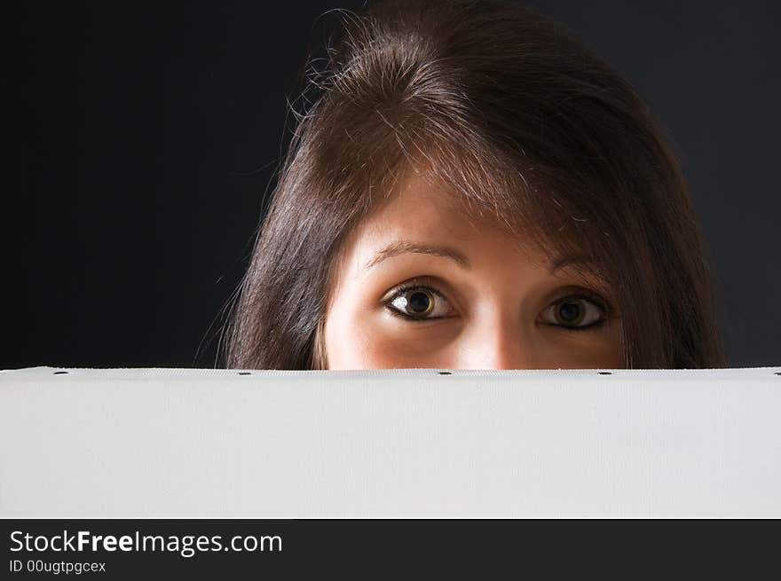 A beautiful and attractive girl holding a billboard. Ready to add your own text. Copy-space on a sign or poster. Young girl holding a sign, advertisement or poster. The concept of this picture is: copy-space on a white board or advertising. A beautiful and attractive girl holding a billboard. Ready to add your own text. Copy-space on a sign or poster. Young girl holding a sign, advertisement or poster. The concept of this picture is: copy-space on a white board or advertising.