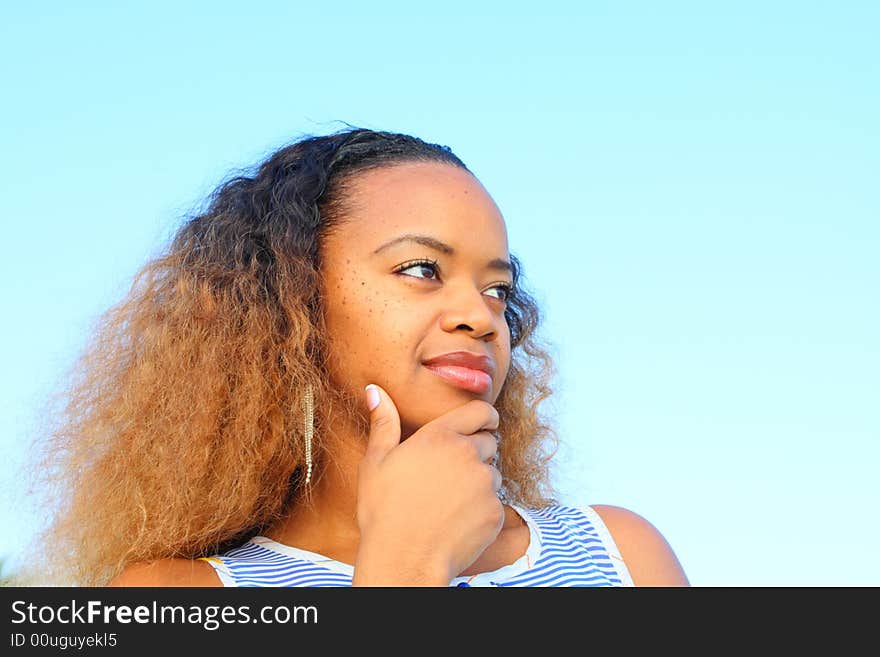 Woman smiling with her hand on her chin.