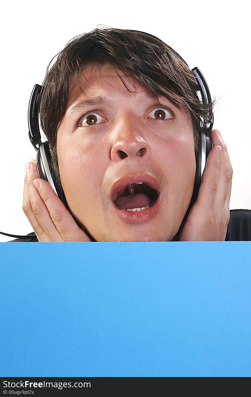 Young man with headphones and blue billboard