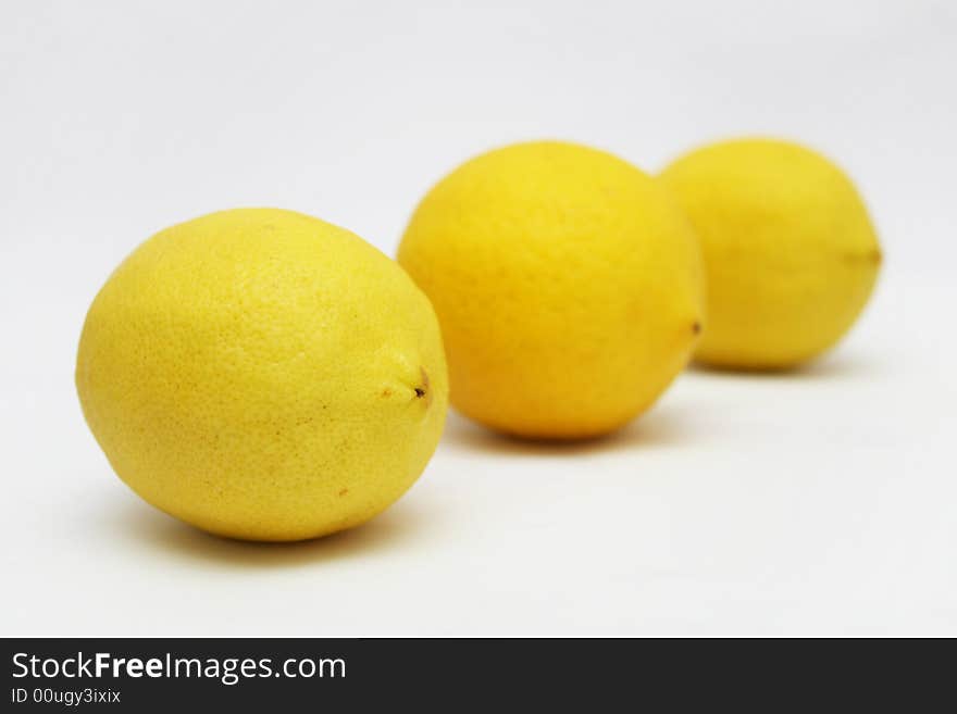 Three lemons in perspective view with white background