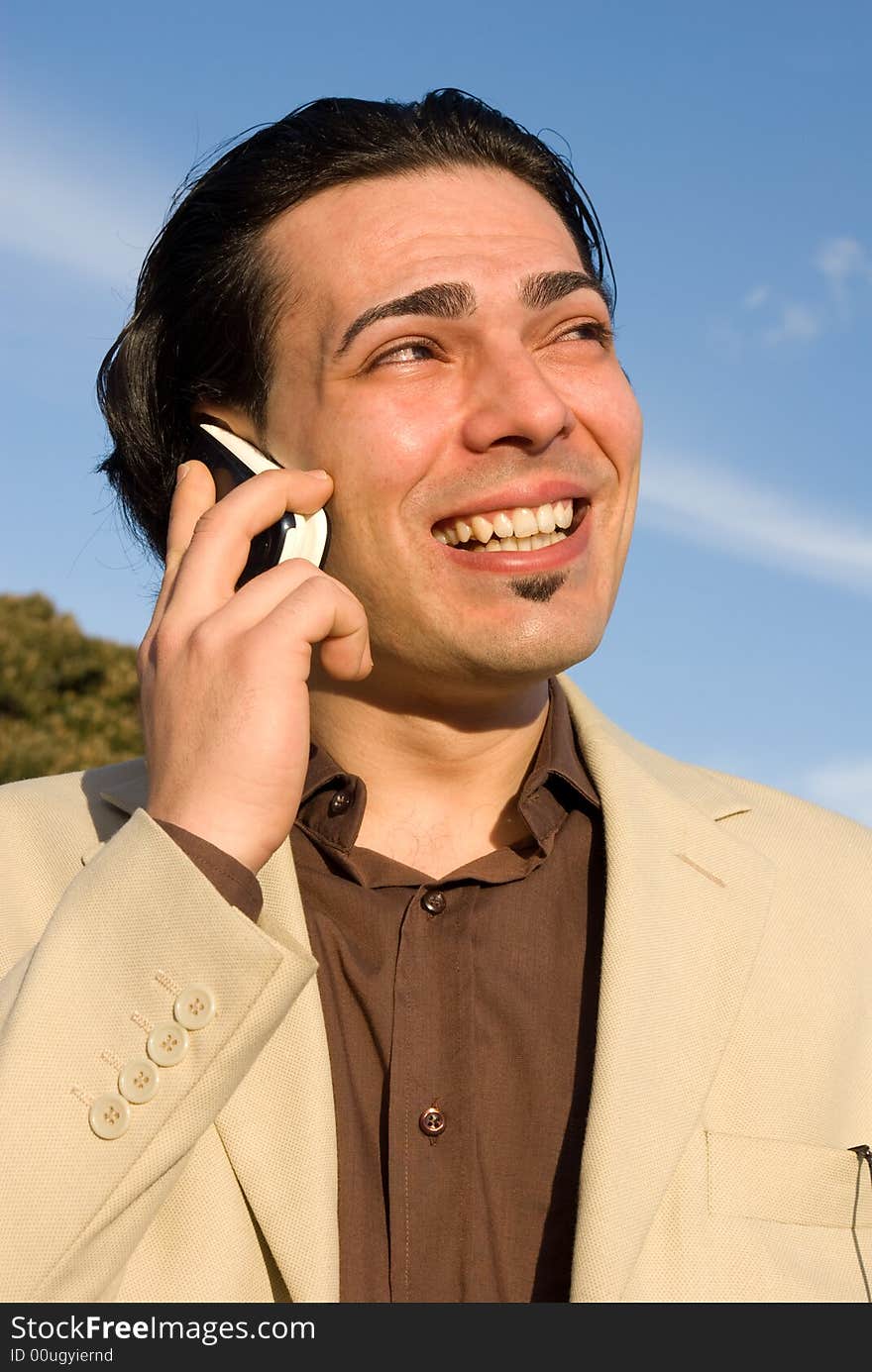 Young man with mobile phone smiling. Young man with mobile phone smiling