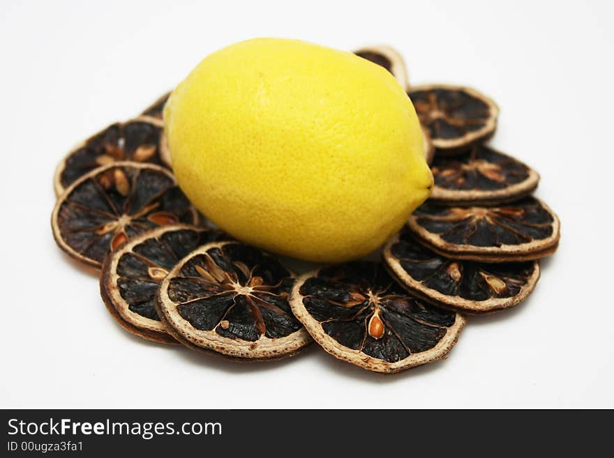 Fresh lemon stand in the middle of dried lemon slices. Fresh lemon stand in the middle of dried lemon slices