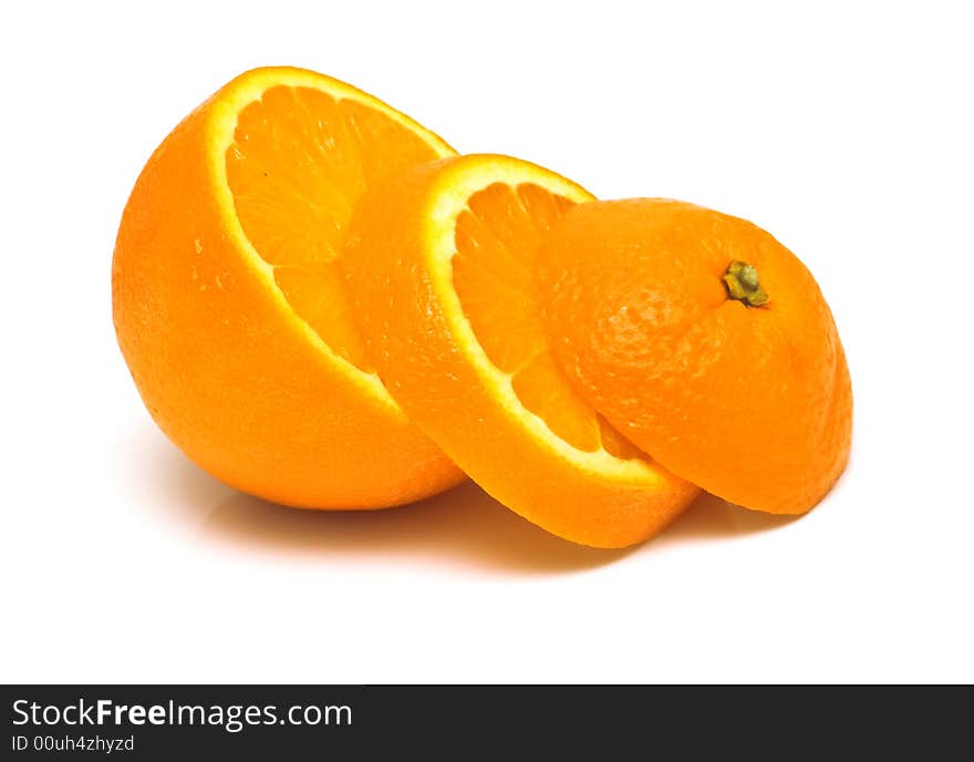 Fresh orange on white. The peel of fruit is covered by drops of water. Isolation, shallow DOF.