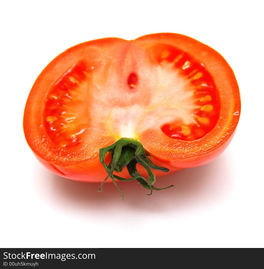 The ripe tomato is isolated on white. Shallow DOF.