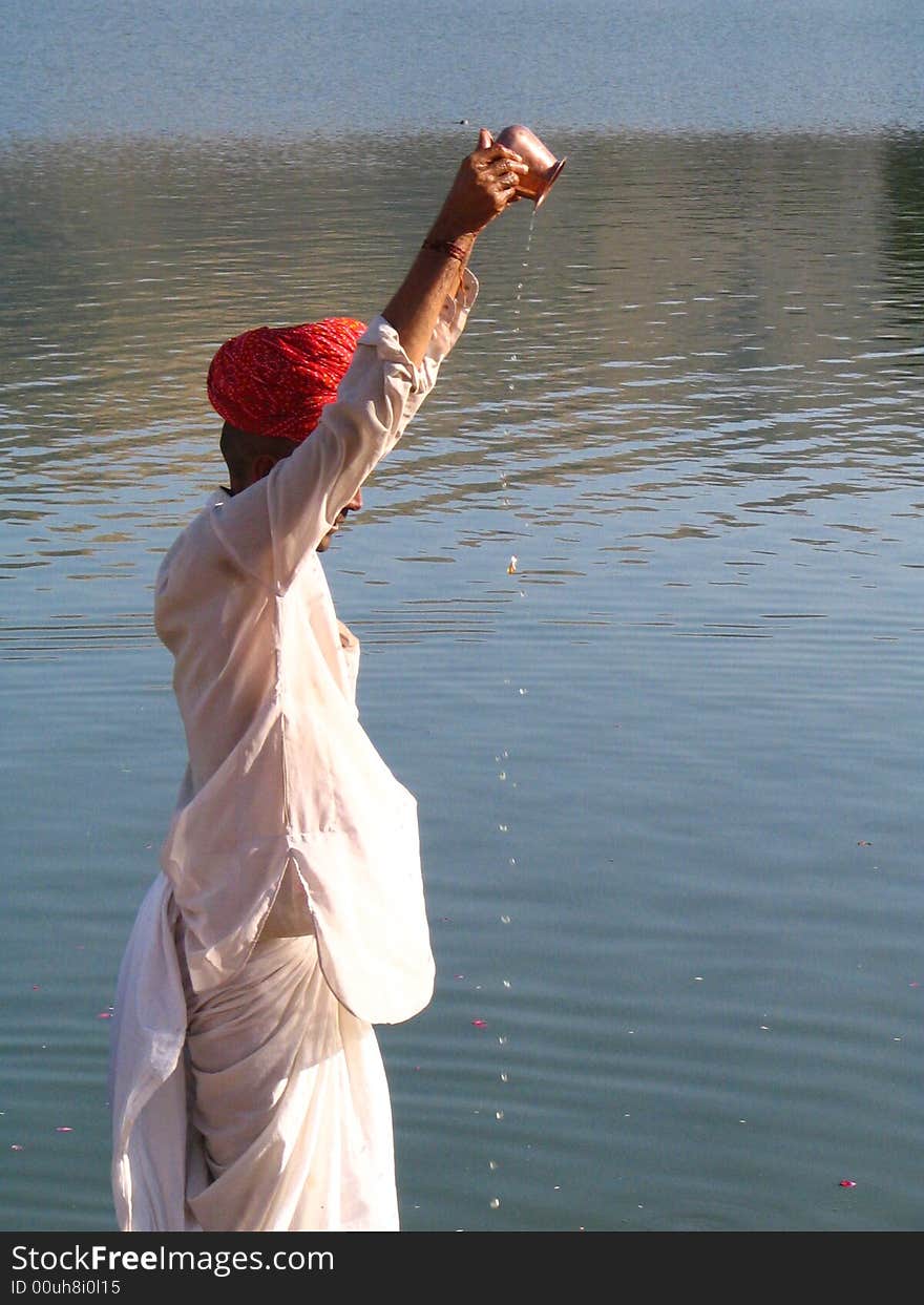 Hindu people worship all the natural elements like water, fire etc. They have a tradition of worshiping nature itself like sun, river etc. Here the man is doing \Surya Puja\ at Pushkar lake, Rajathan. Hindu people worship all the natural elements like water, fire etc. They have a tradition of worshiping nature itself like sun, river etc. Here the man is doing \Surya Puja\ at Pushkar lake, Rajathan.