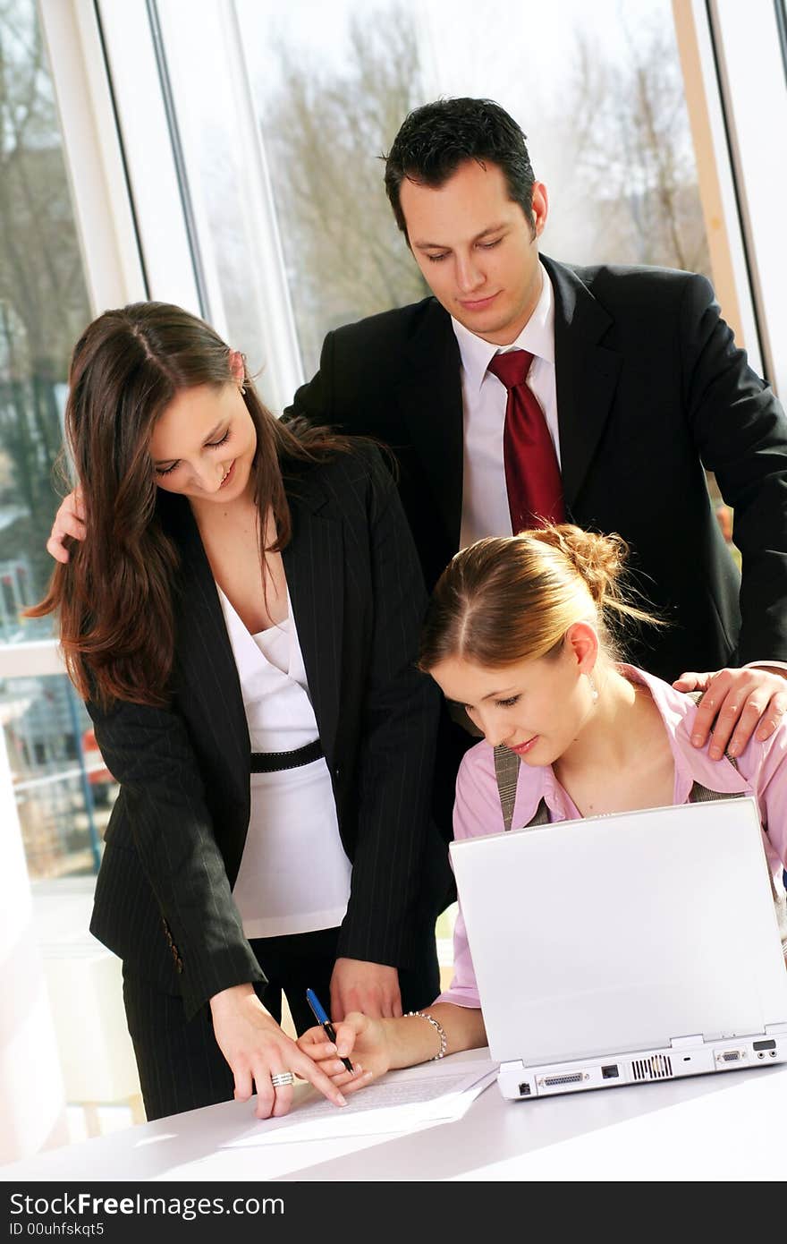 A successful business team with a document on a table with a laptop