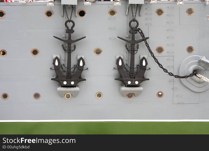 Two anchors, chains, bow windows at the old big Russian warship - cruiser