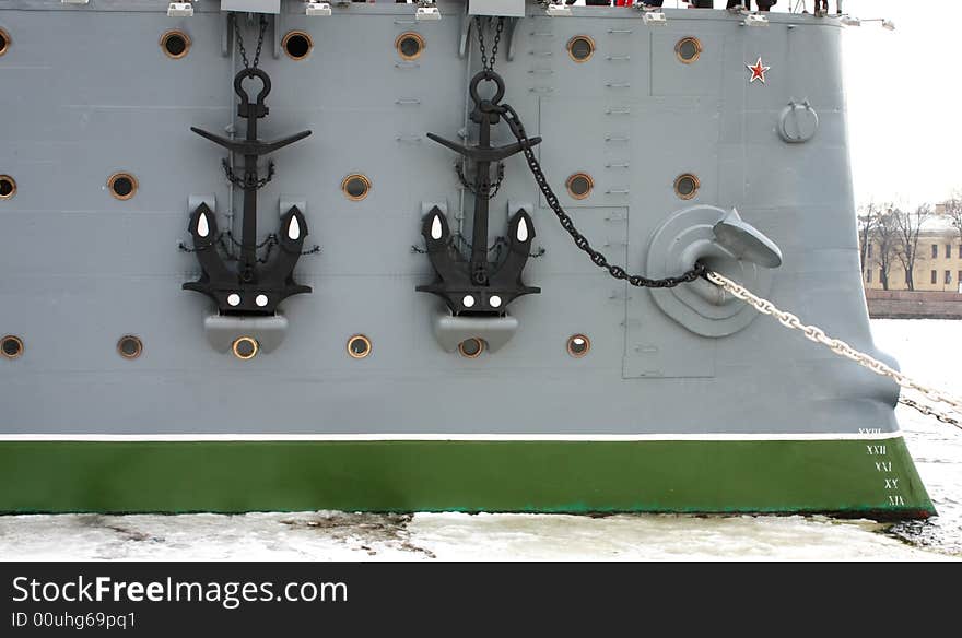 Two anchors, chains, bow windows at the old big Russian warship - cruiser