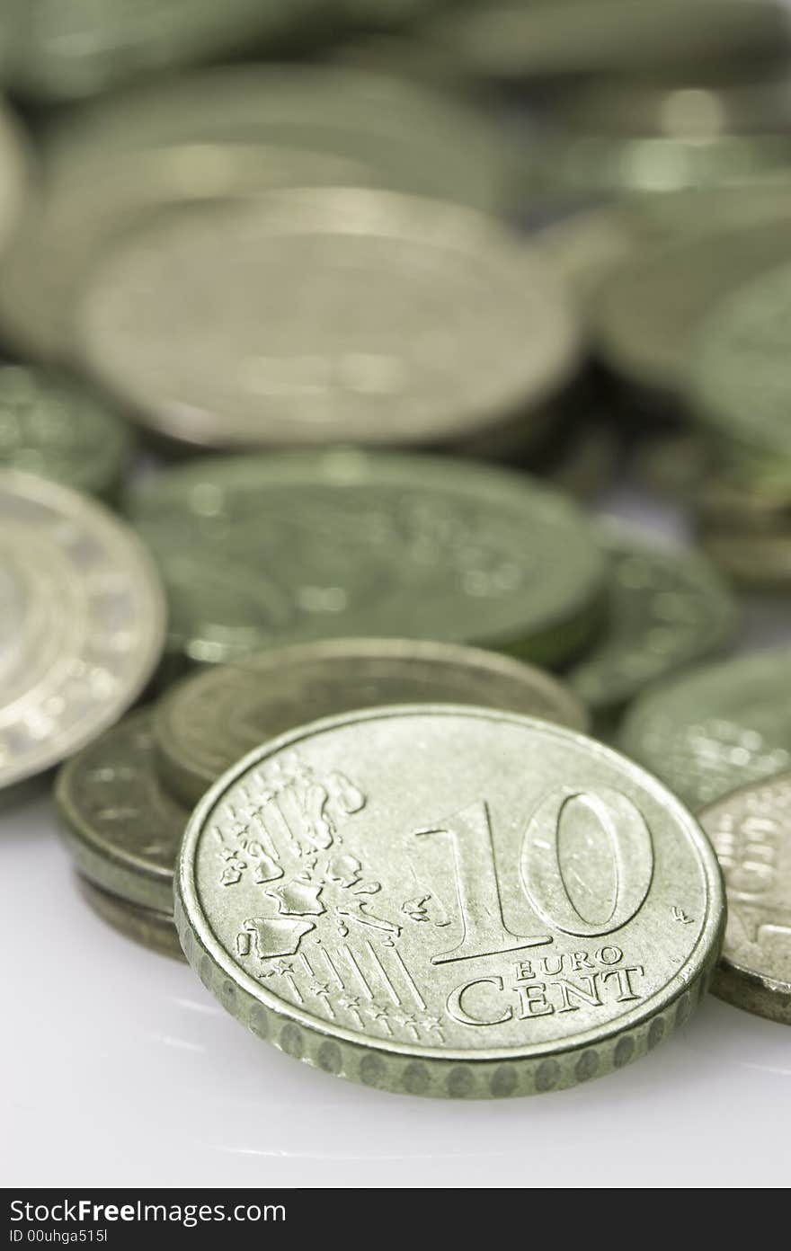 Euros with focus on a 10 cent coin. Green.