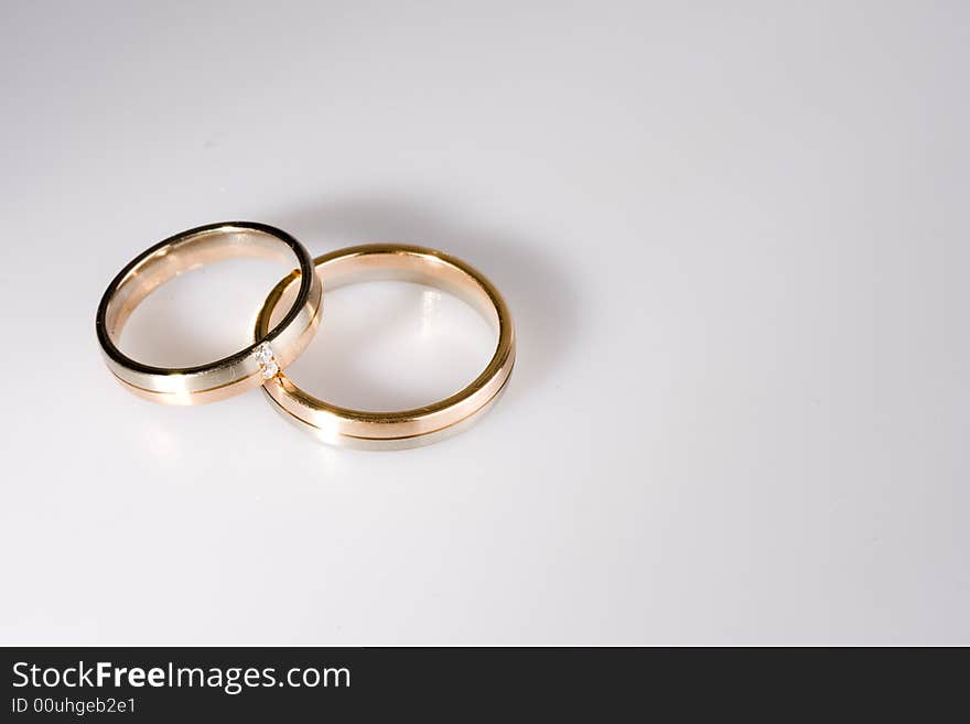 Golden rings on a neutral white backround