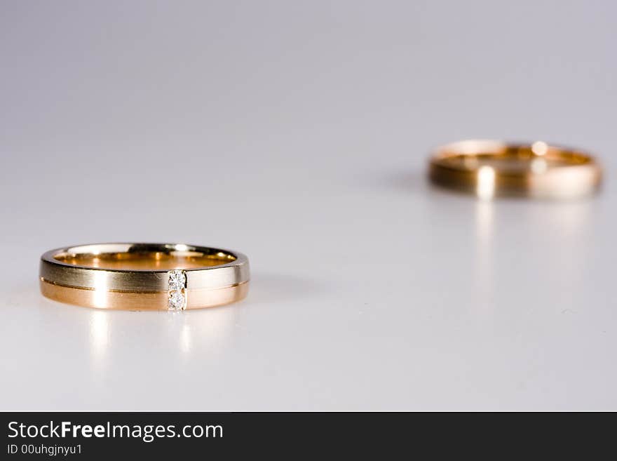 Golden rings on a neutral grey backround