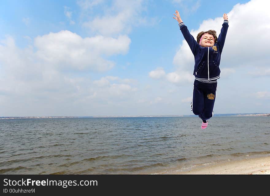 Jumping child on river background