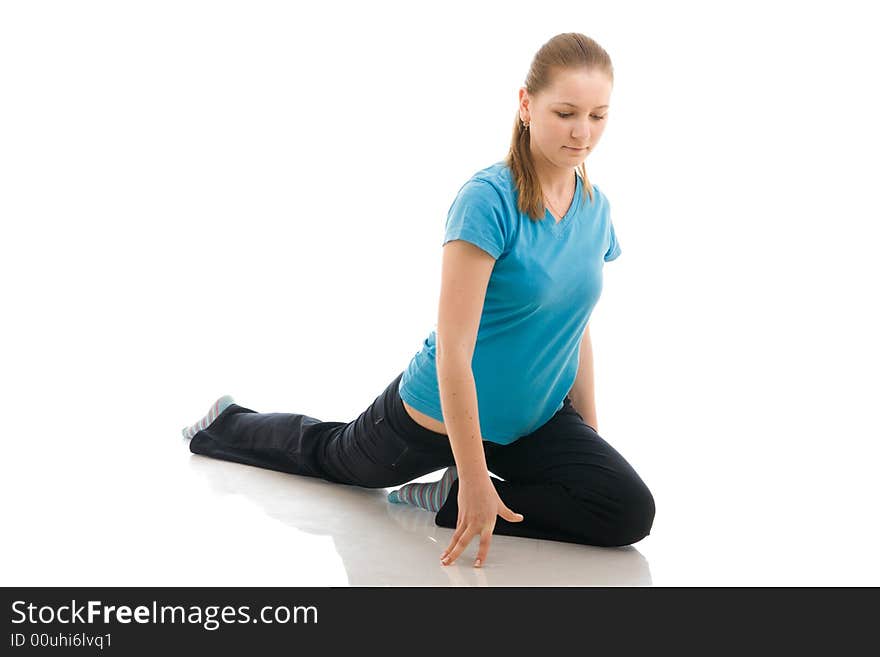 The young woman doing yoga exercise isolated on a white background