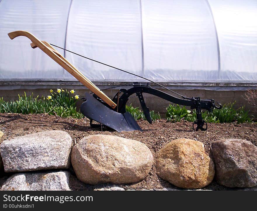 Antique farm plow used for cutting and turning up soil, Indian garden farm Bridgewater Lunenburg County Nova Scotia Canada. Antique farm plow used for cutting and turning up soil, Indian garden farm Bridgewater Lunenburg County Nova Scotia Canada