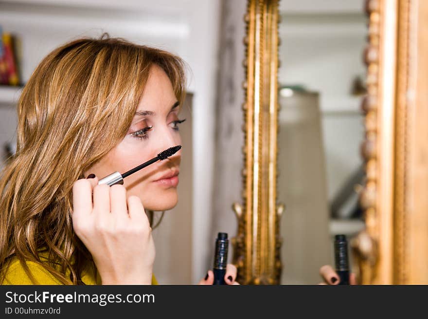 Woman applying cosmetic with applicator. Make-up treatment. Woman applying cosmetic with applicator. Make-up treatment.