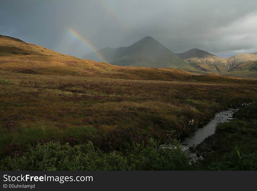 Evening rainbow in scottish highlands. Evening rainbow in scottish highlands.