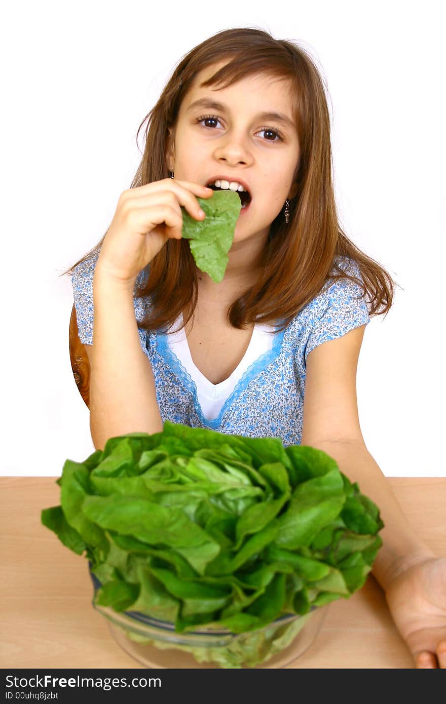 Girl eating a salad a over white background