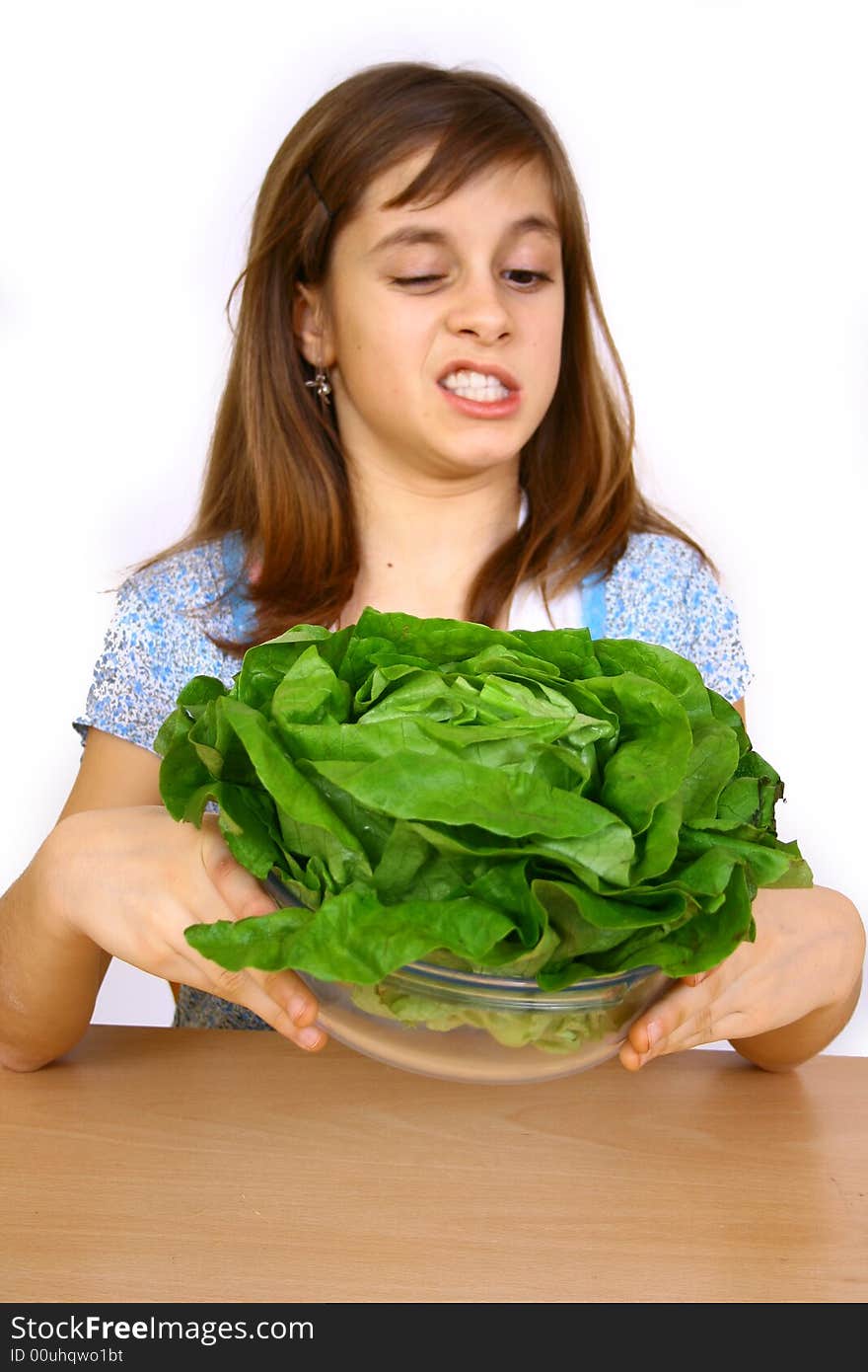 Girl eating a salad a over white background