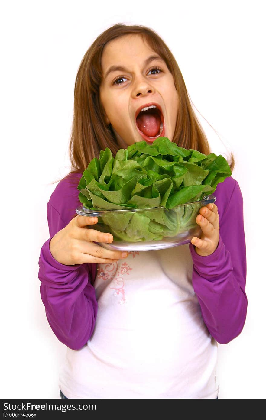 Girl eating a salad a over white background