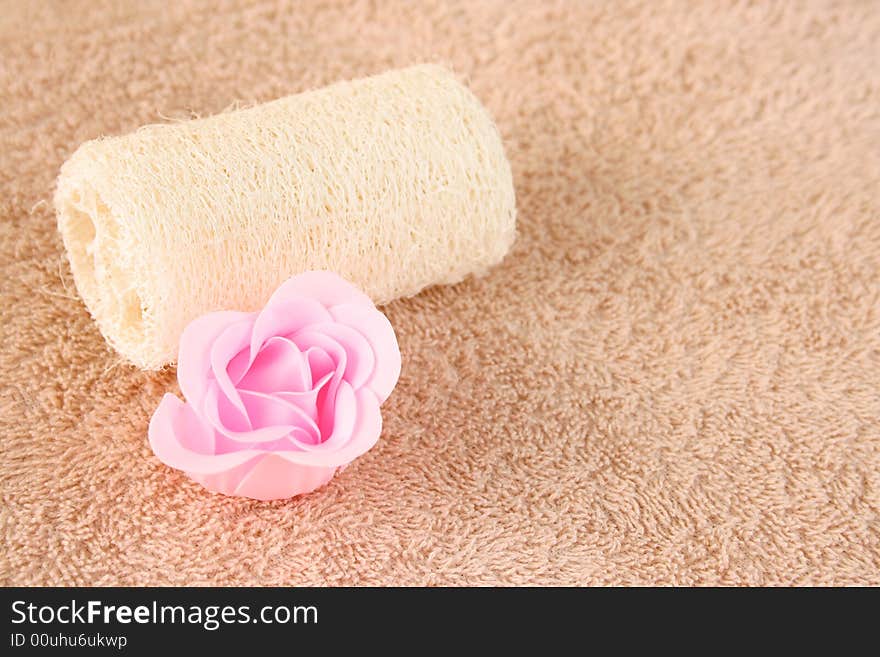 Pink soap flower and a skin scrub sponge