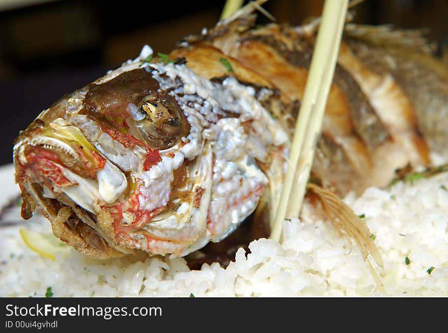 Whole prepared fish with rice