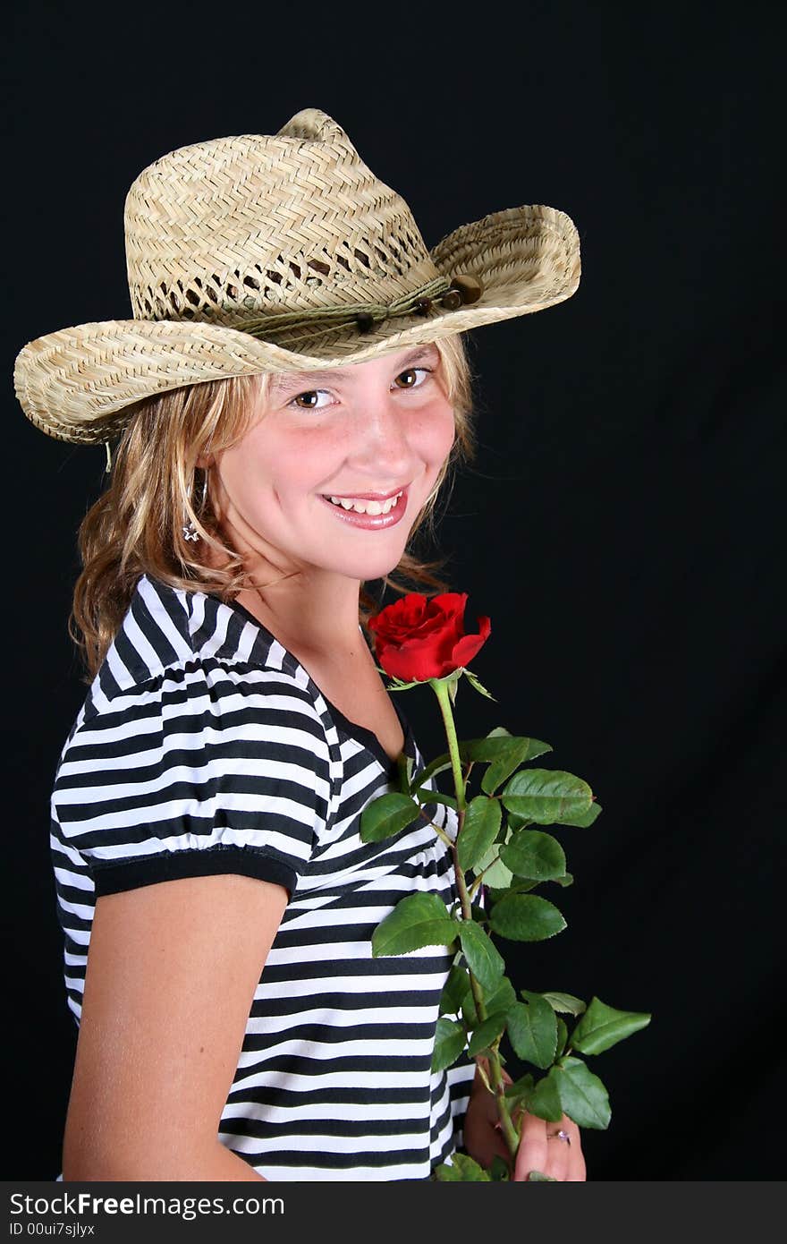 Teenage girl with a straw hat and red rose. Teenage girl with a straw hat and red rose