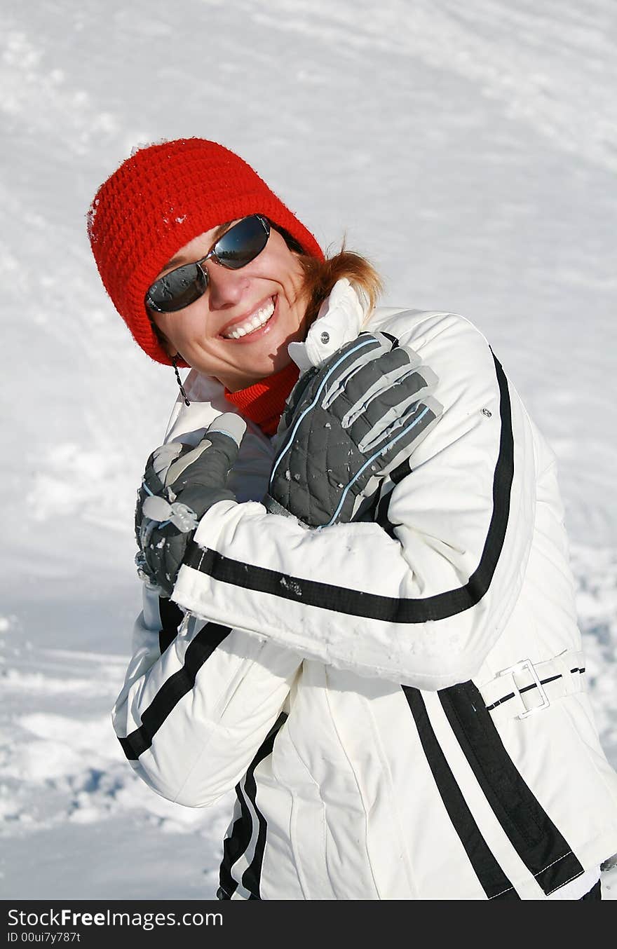 Happy woman plays with snow