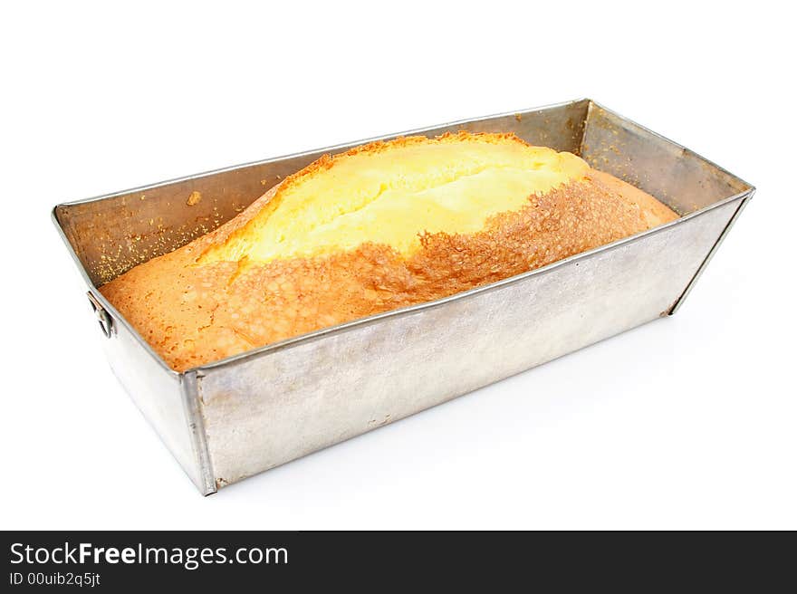 Home made cake in tin over white background