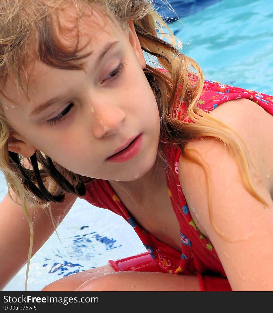 This is my daughter comng out of the pool all wet in florida wth a funny look on her face with the water dripping of her face and hair. This is my daughter comng out of the pool all wet in florida wth a funny look on her face with the water dripping of her face and hair