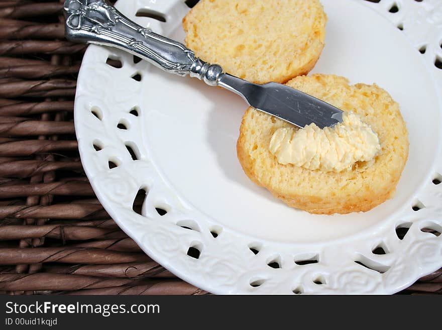 Early Morning Scones with butter on a white plate. Early Morning Scones with butter on a white plate