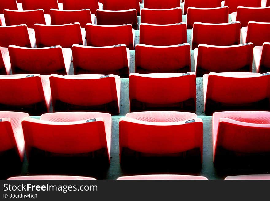 Rows of chairs in perfect line and symmetry vacant to anyone. Rows of chairs in perfect line and symmetry vacant to anyone.