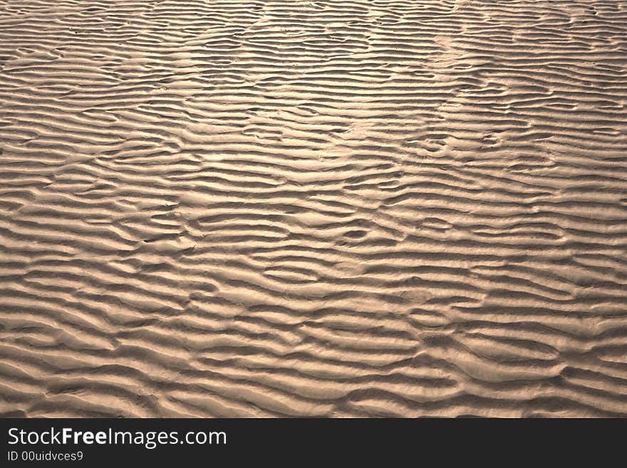 Rippled sand on picturesque beach.