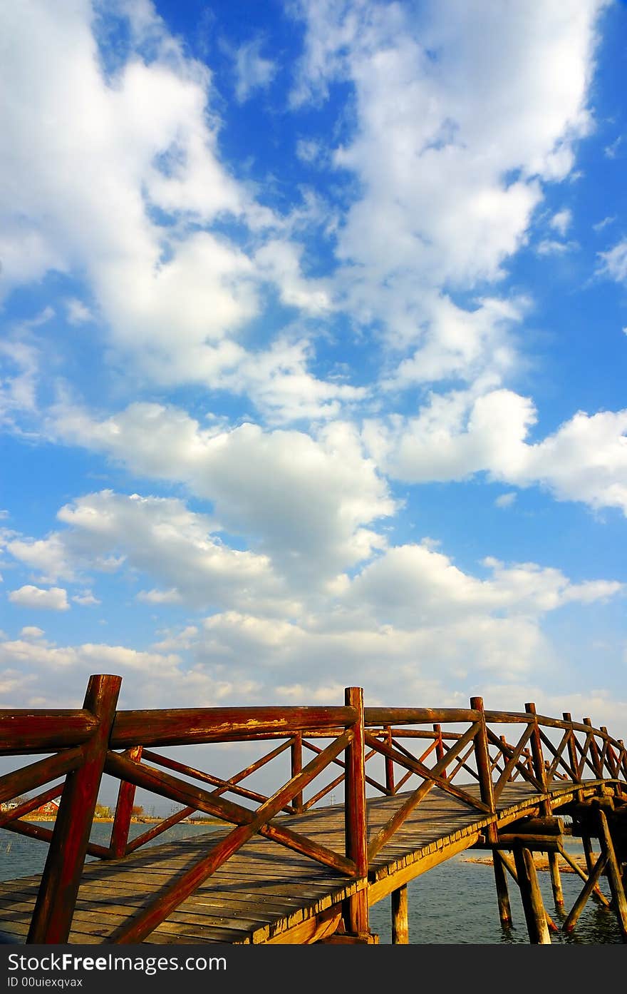 Wooden arch  bridge under the sky and clouds. Wooden arch  bridge under the sky and clouds