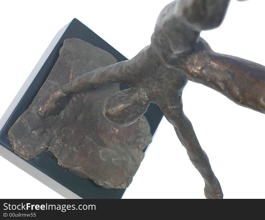 Close up of a bronze statue of a gymnast standing on one hand spreading legs over white background, side view. Close up of a bronze statue of a gymnast standing on one hand spreading legs over white background, side view