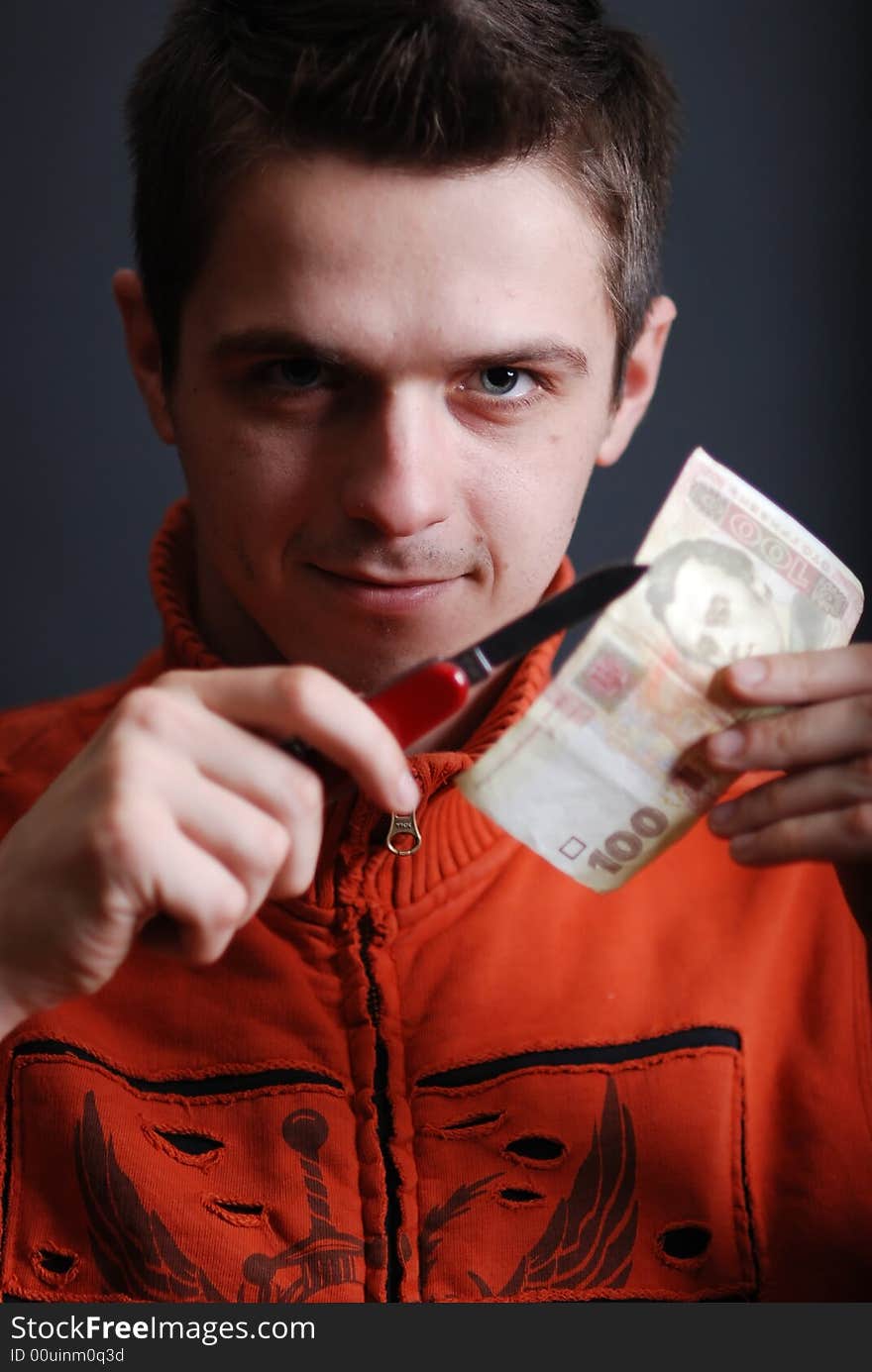 Young man cut money at black back