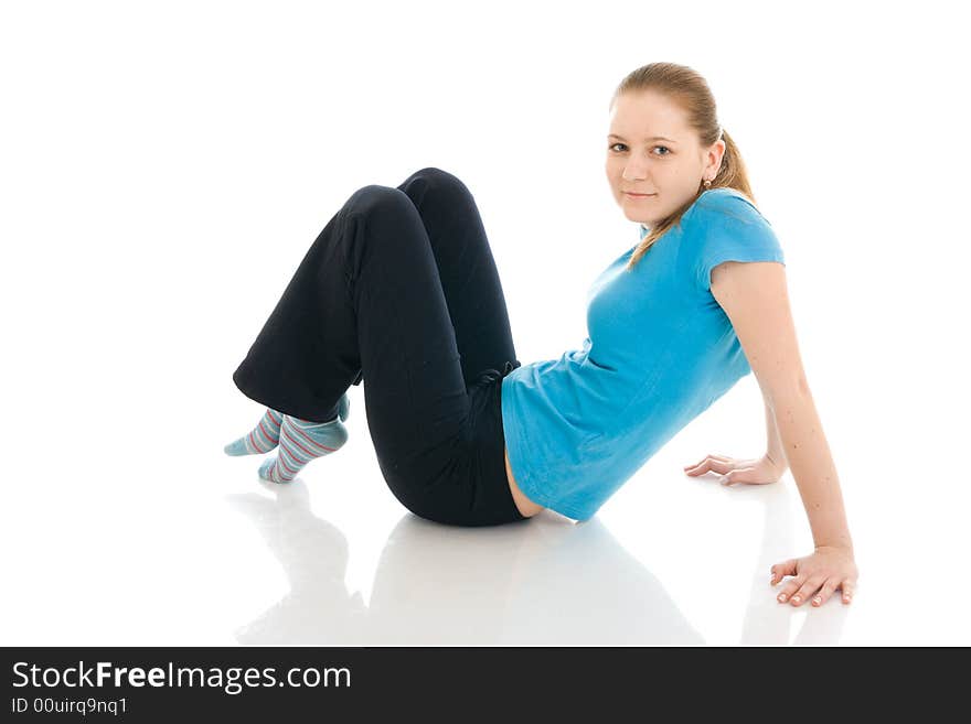 The young woman doing exercise isolated on a white