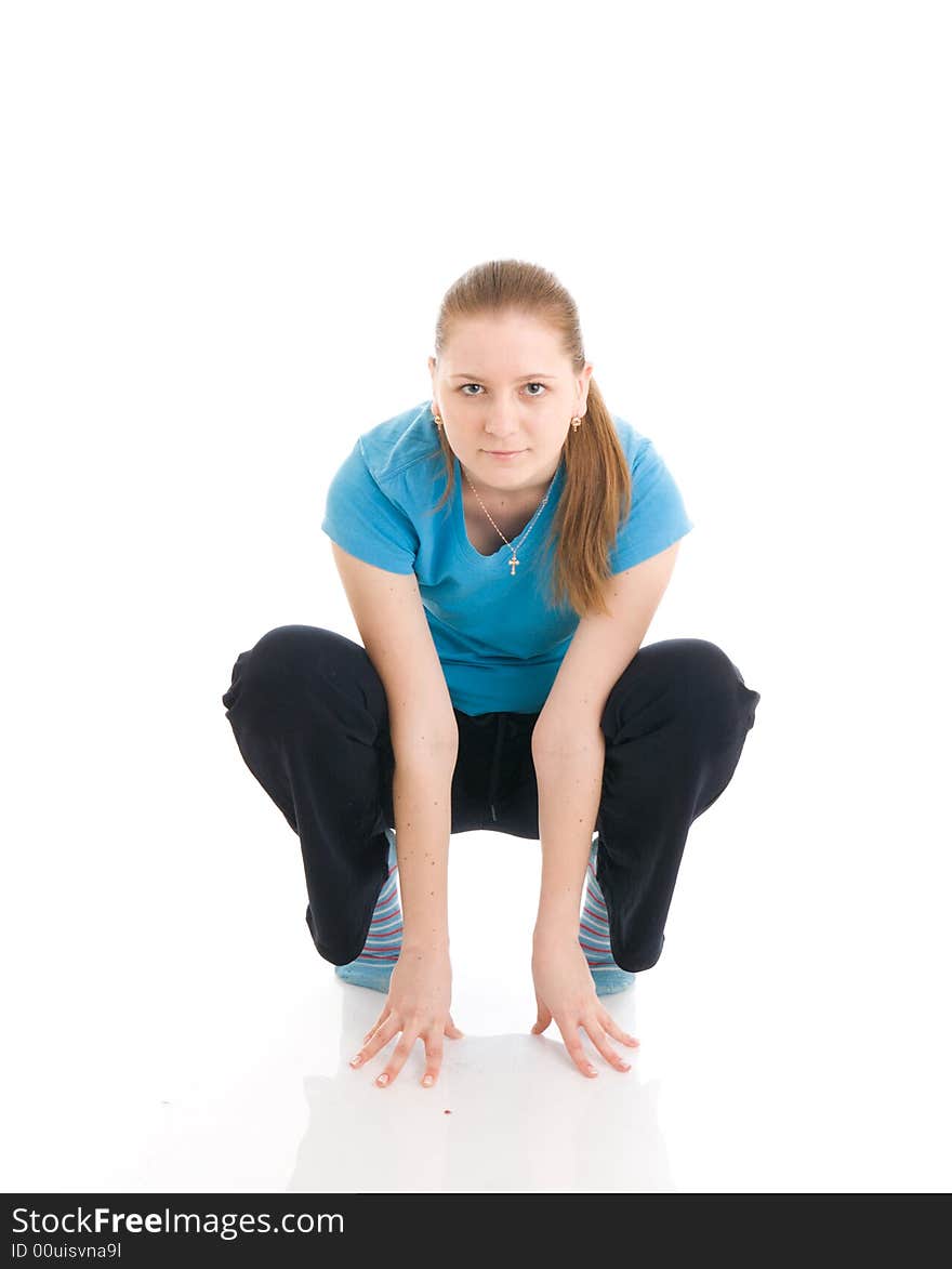 The young woman doing exercise isolated on a white