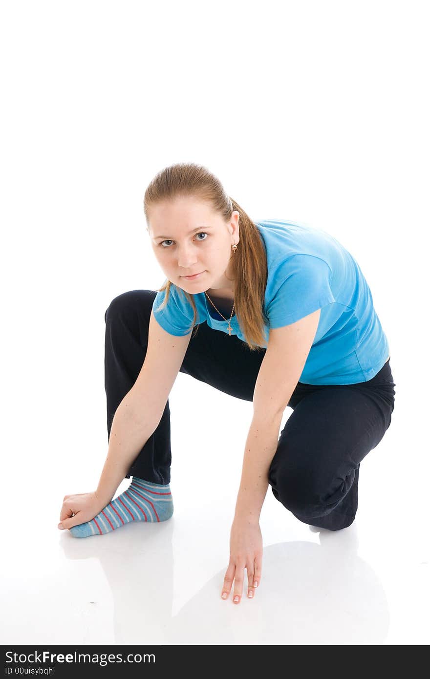 The young woman doing exercise isolated on a white