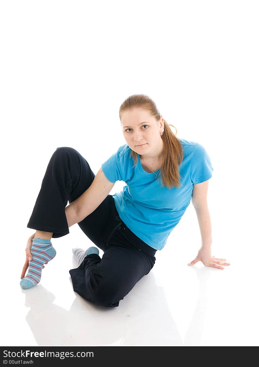 The Young Woman Doing Exercise Isolated On A White