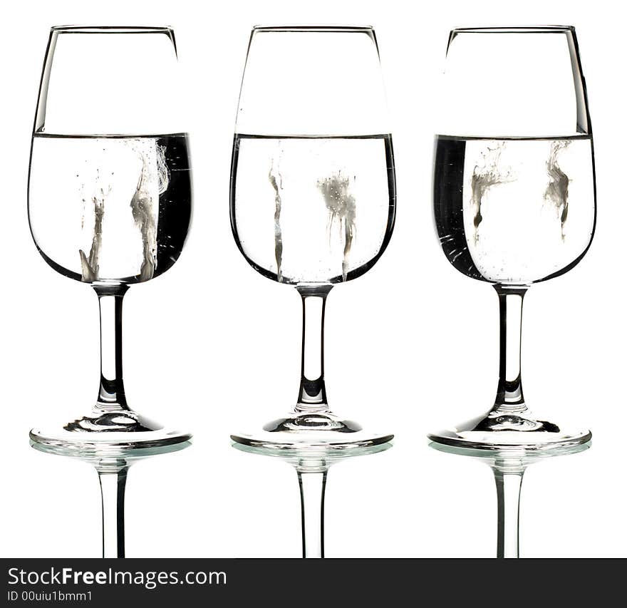 Silhouette of three glasses containing a creamy splatter