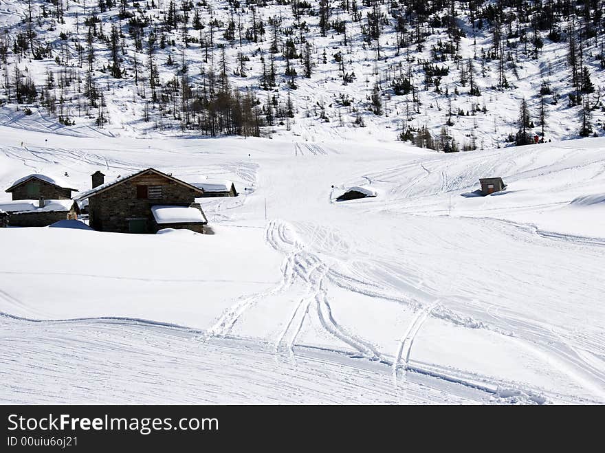 Mountain huts under snow