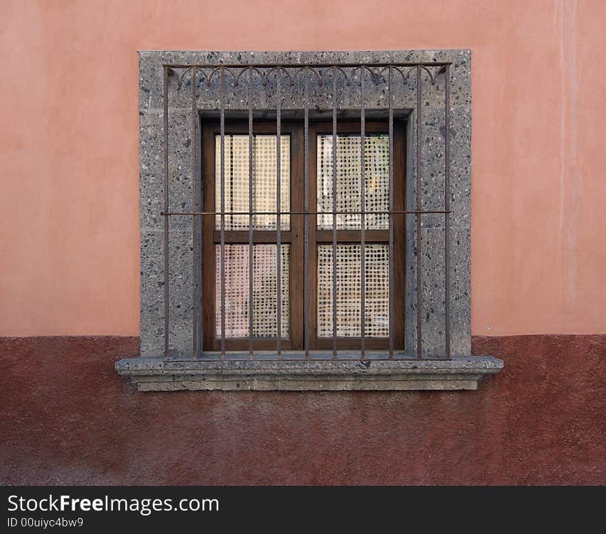 Window with wrought iron grill in the classic Spanish colonial mountain silver mining town of San Miguel de Allende, Mexico. Window with wrought iron grill in the classic Spanish colonial mountain silver mining town of San Miguel de Allende, Mexico