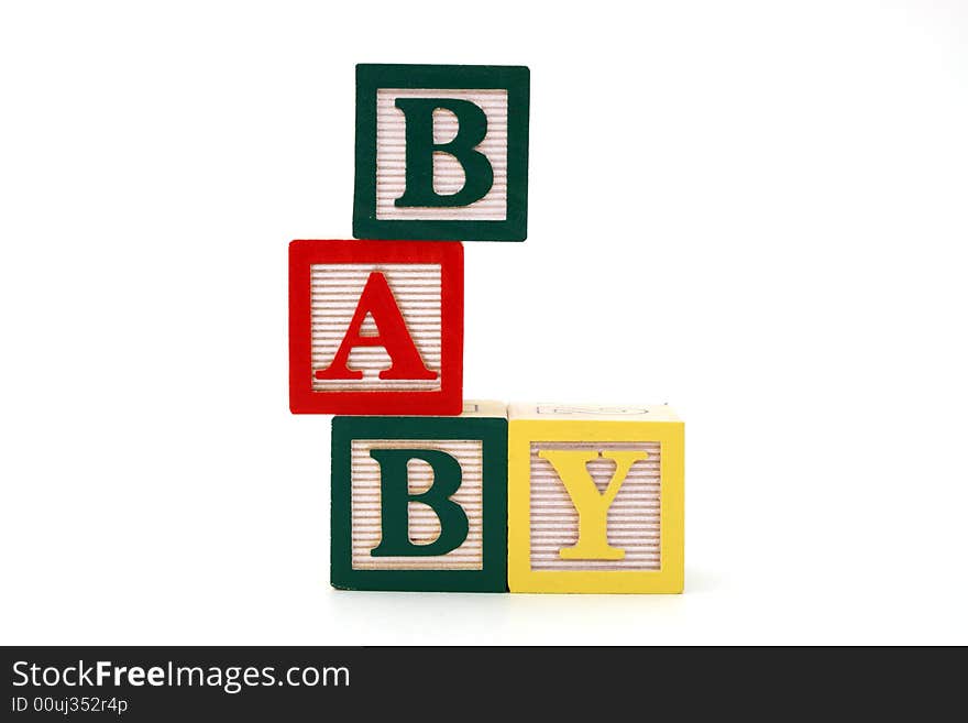 Word baby formed by alphabet wood blocks on a white surface