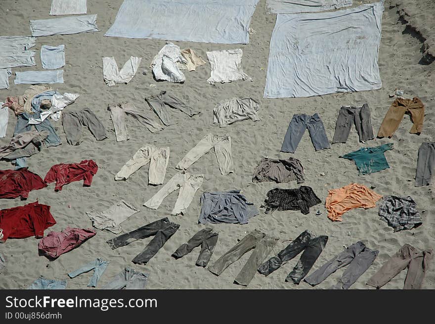 Clothes drying on sandy river bank, Agra, India