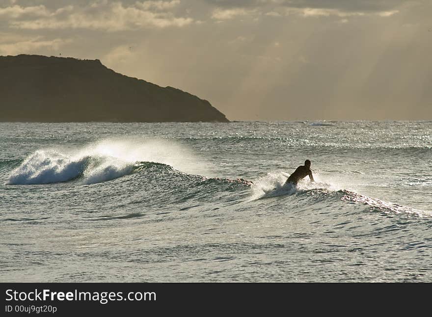 A bodyboarder rides a wave in one of many Australias beaches. A bodyboarder rides a wave in one of many Australias beaches