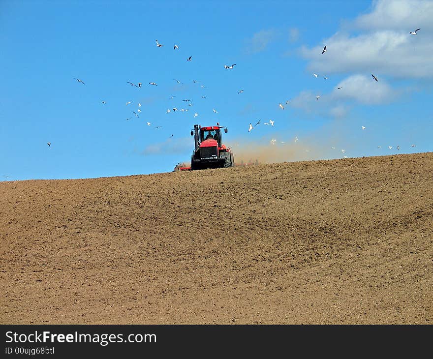 Big tractor plowing a field