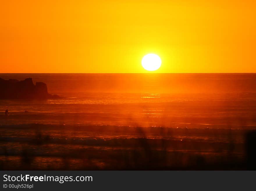 Last rays of a gorgeous sunset at Piha beach