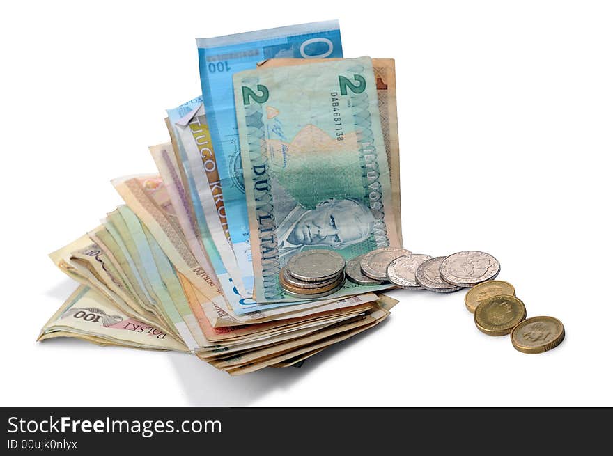 Banknotes and coins spread randomly on a table.